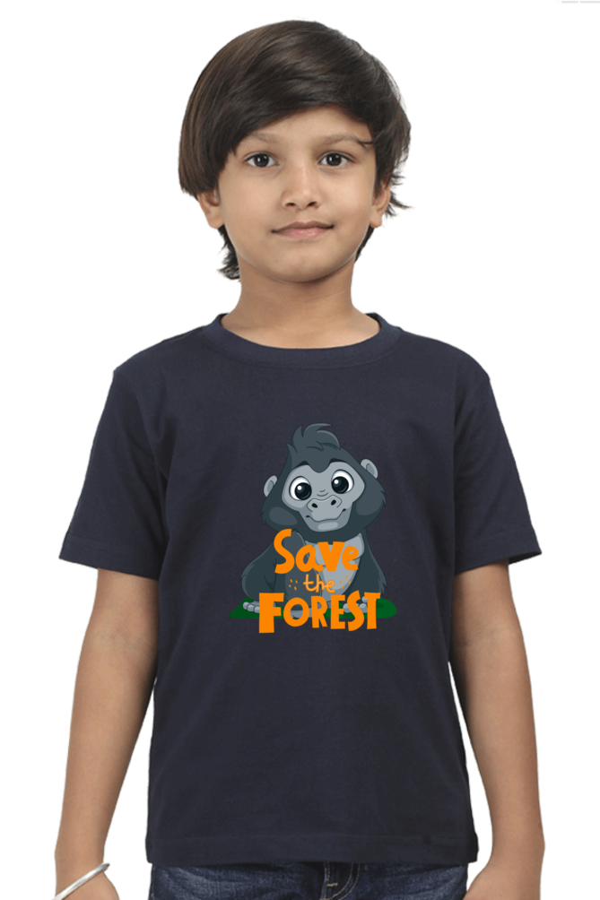 A young child with short dark hair wears a SAVE THE FOREST Boys T-Shirt by TuckTribe, featuring a cartoon mountain gorilla and Forest Guardian in orange and yellow.