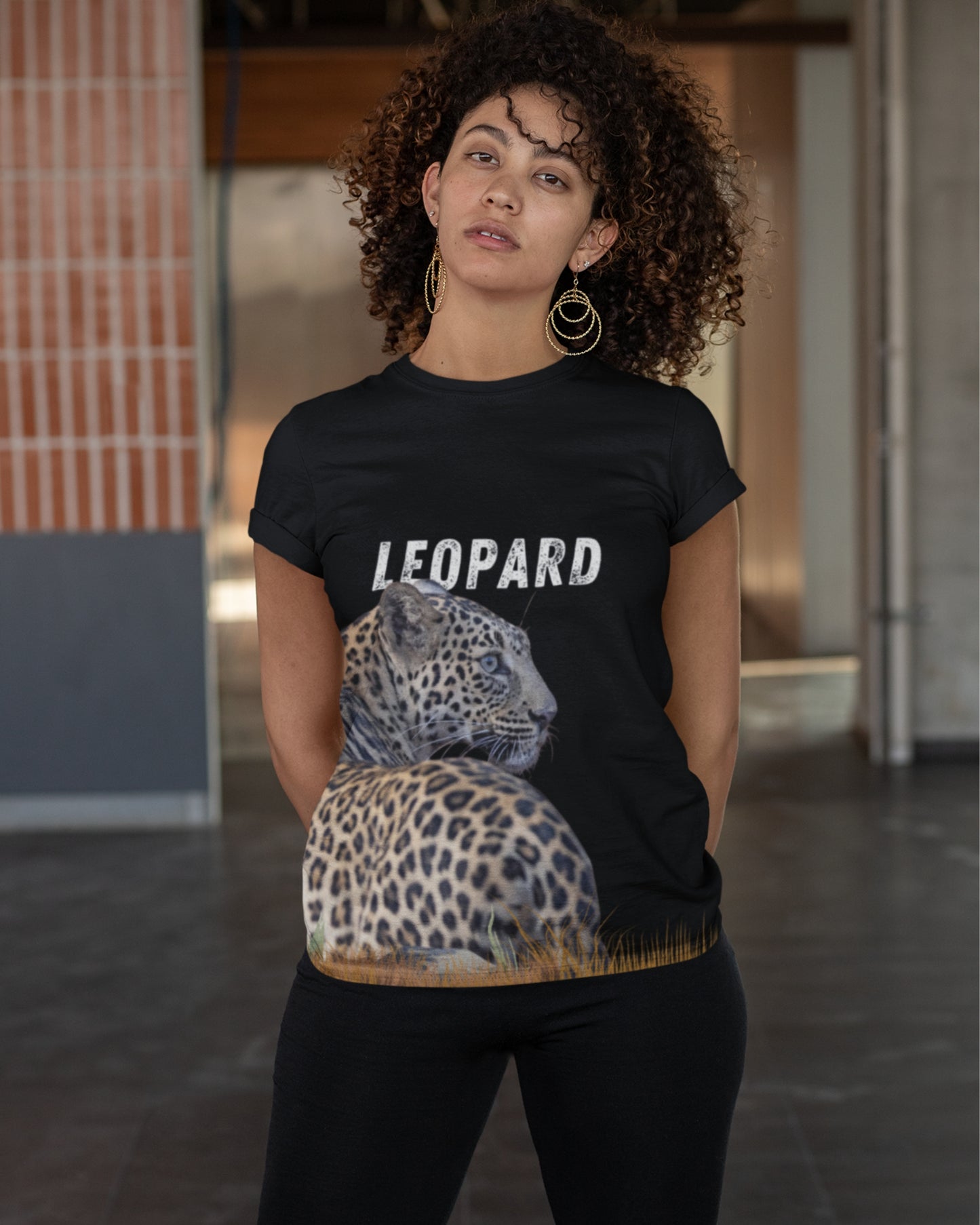 woman wearing a tshirt with leopard graphic and text LEOPARD