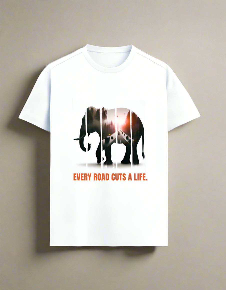 White wildlife conservation T-shirt with artistic elephant silhouette showing forest and highway inside, printed with "Every Road Cuts a Life" slogan.