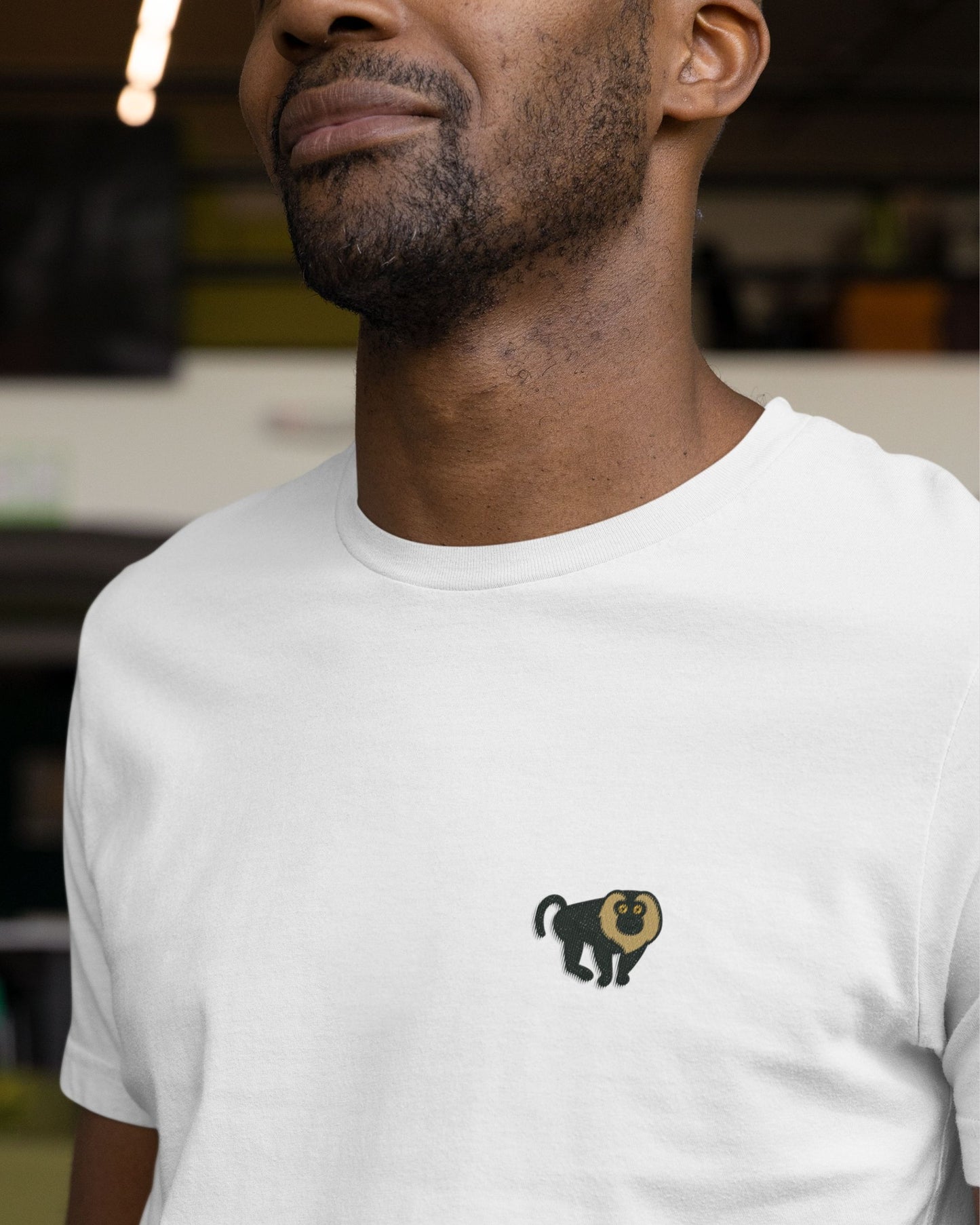 man wearing Lion tailed macaque embroidered wildlife t shirt in white by Tucktribe