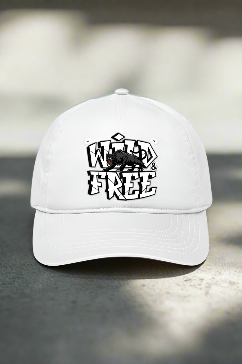 The WILD AND FREE PANTHER PRINT BASEBALL CAP by TuckTribe features bold, stylized Wild & Free lettering and a small wolf graphic on the front. Perfect for embracing your adventurous spirit against a neutral background.