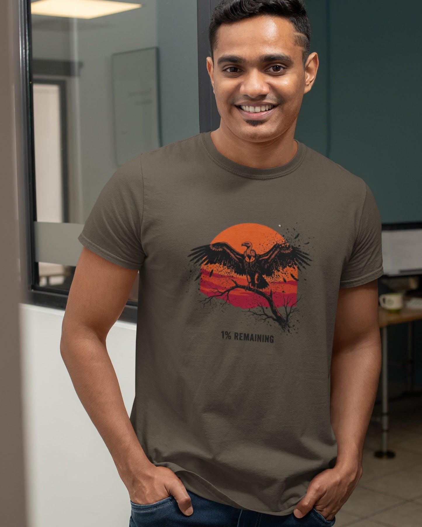 Man wearing a Olive green Tucktribe t-shirt with an vulture design in an office setting.