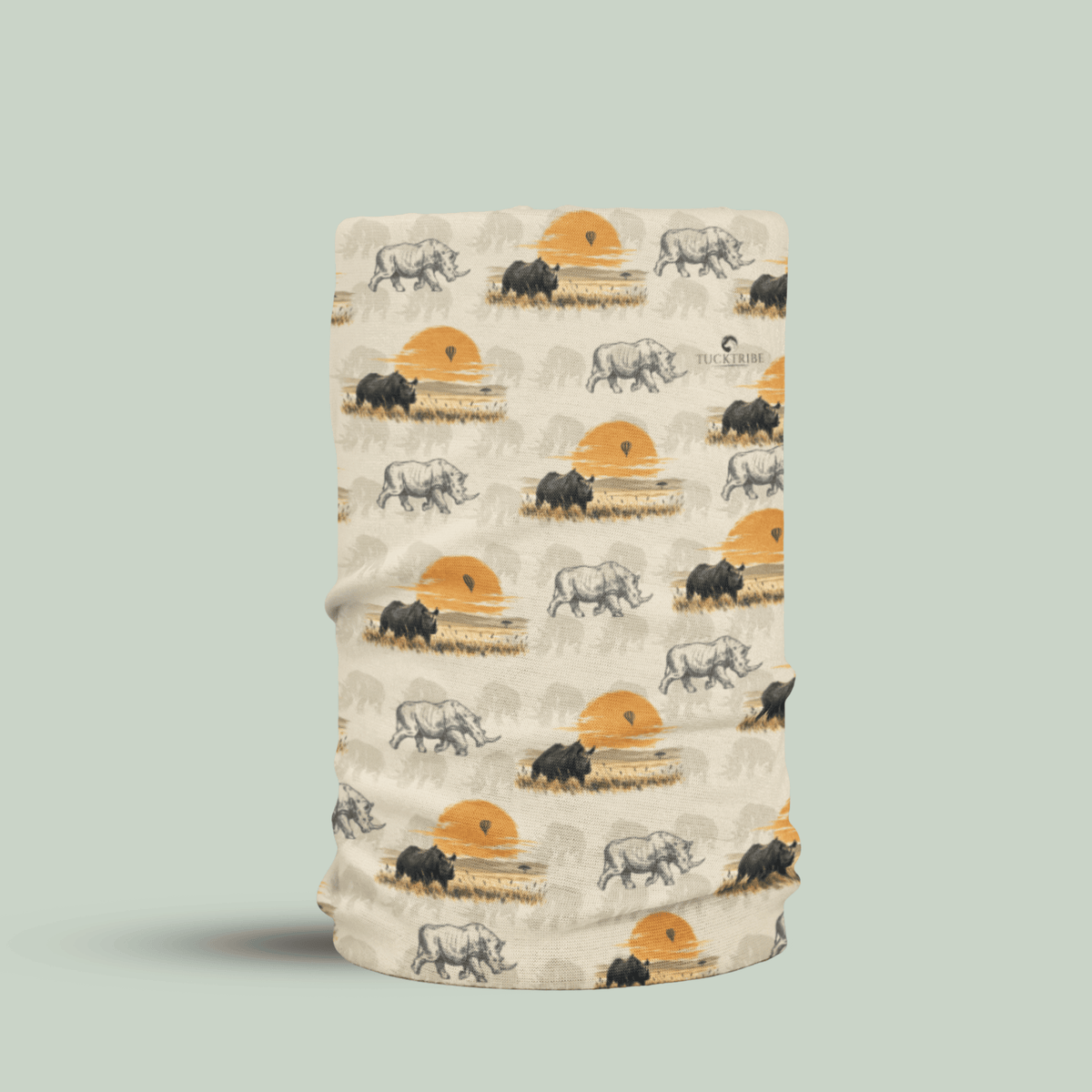 A rolled fabric neck gaiter or face mask with an all-over safari print featuring rhinos and sunsets on a light beige background, set against a solid sage green backdrop.