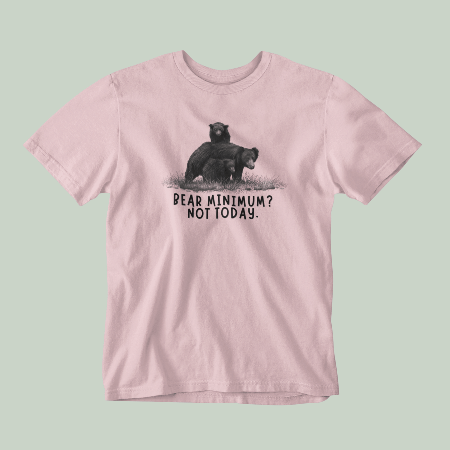 Pink t-shirt with bear graphic and text on a light green background