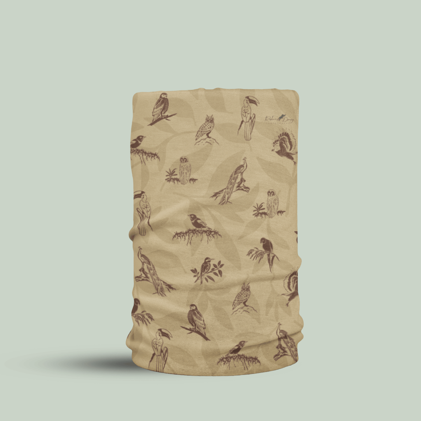 A beige neck gaiter or face mask featuring a brown pattern of various birds perched on branches, shown against a solid light sage green background.