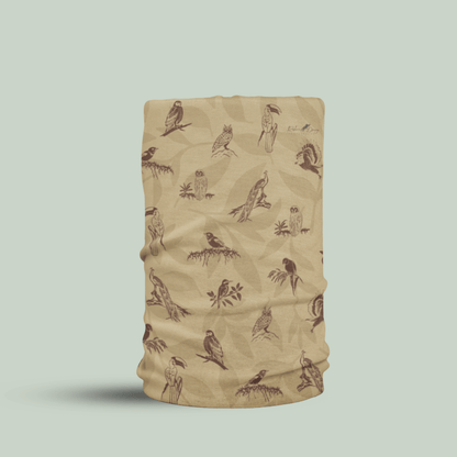 A beige neck gaiter or face mask featuring a brown pattern of various birds perched on branches, shown against a solid light sage green background.