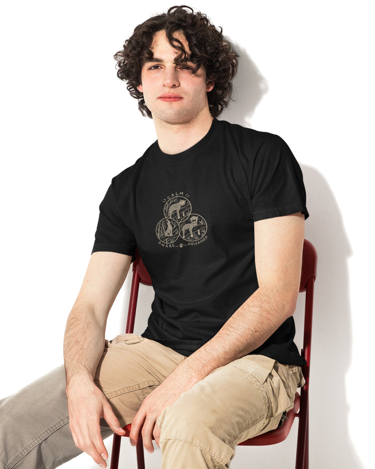 Man wearing a Black unisex leopard wildlife T-shirt with three illustrated leopard designs inspired by Rashmi Dsouza wildlife photography