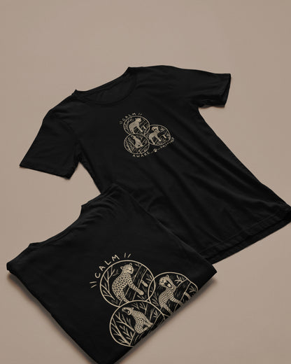 two Black unisex leopard wildlife T-shirt with three illustrated leopard designs inspired by Rashmi Dsouza wildlife photography, one is a folded tshirt and other spread.