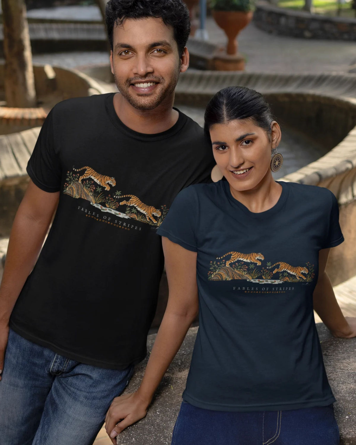 a boy and a girl wearing a black and navy blue Tucktribe Fables of Stripes unisex tiger graphic T-shirt