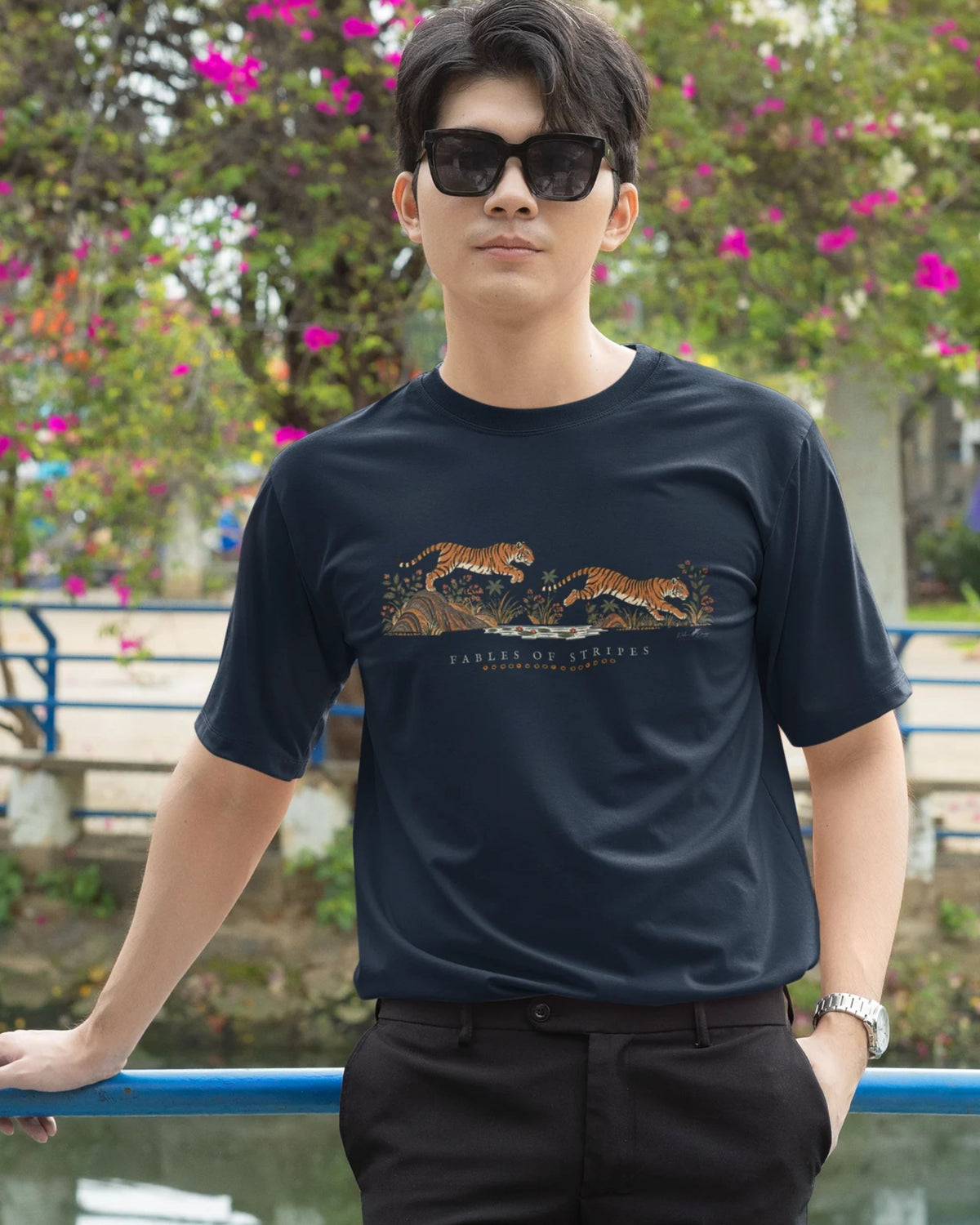 man wearing a navy blue  Tucktribe Fables of Stripes unisex tiger graphic T-shirt