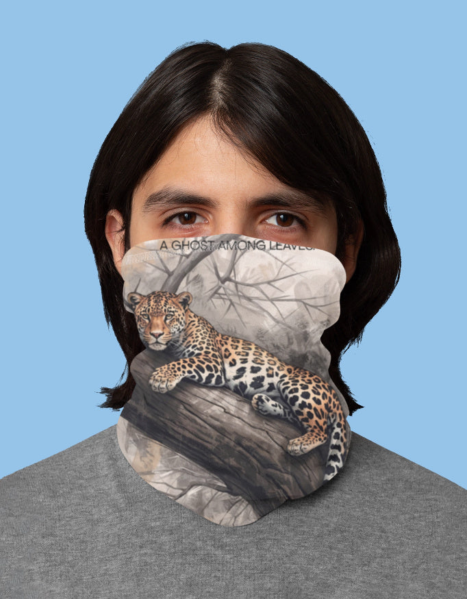 Person wearing a face mask with a leopard design on a blue background
