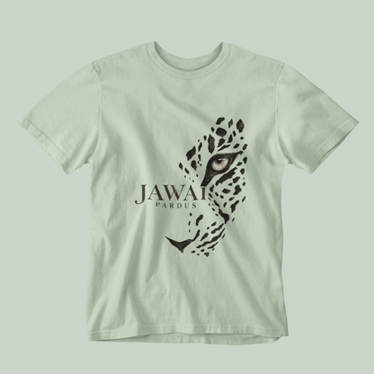 A light sage green short-sleeve t-shirt featuring a graphic print of a leopard's face and the text 'JAWAI PARDUS' on the front, displayed against a matching light sage green background.