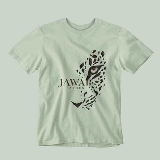 A light sage green short-sleeve t-shirt featuring a graphic print of a leopard's face and the text 'JAWAI PARDUS' on the front, displayed against a matching light sage green background.