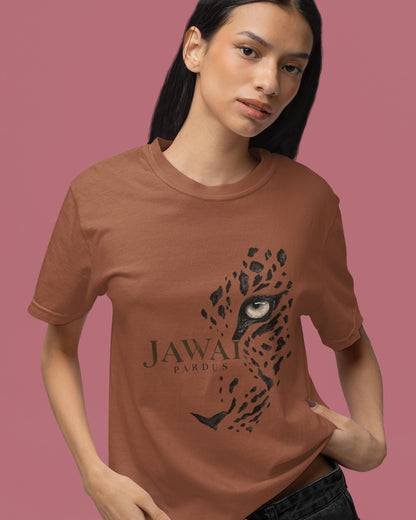 A woman modeling a copper brown short-sleeve t-shirt with a black graphic of a leopard face and the text 'JAWAI PARDUS' on the front, set against a solid dusty pink background.