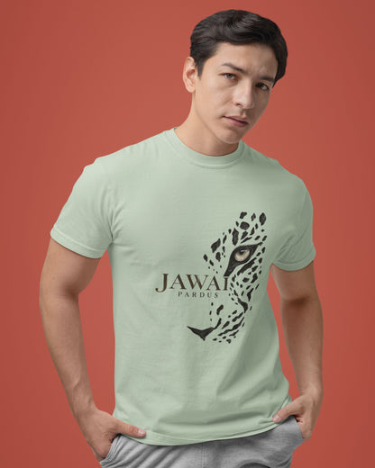 A man wearing a light sage green t-shirt with a black graphic of a jaguar and the text 'JAWAI PARDUS' on the front, posed against a solid terracotta background.