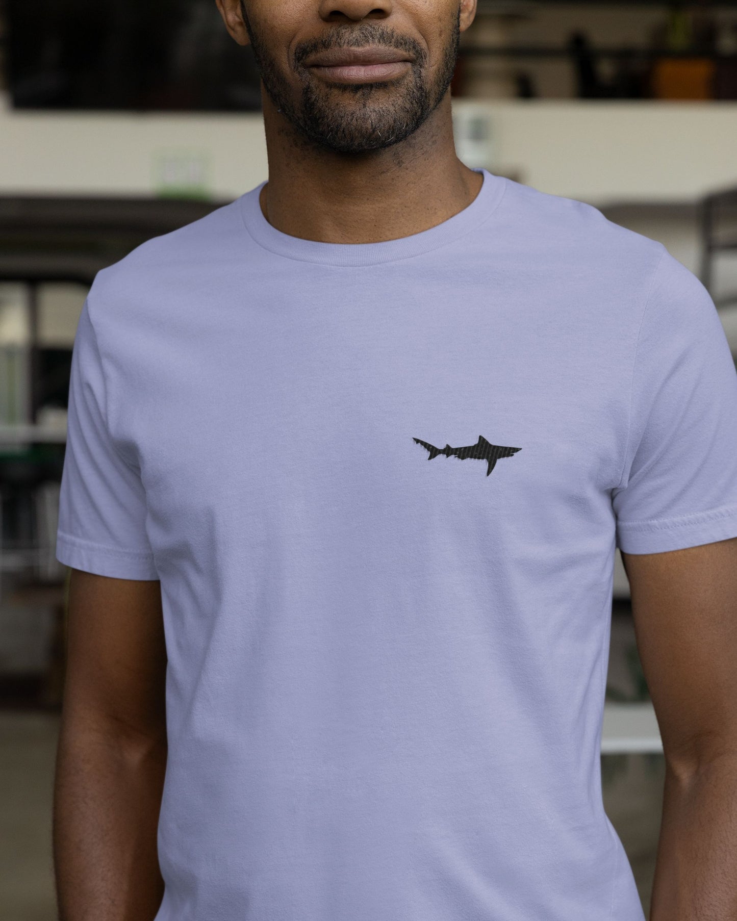 Man wearing Lavender cotton stretch t-shirt with embroidered Ganges Shark wildlife design by Tucktribe