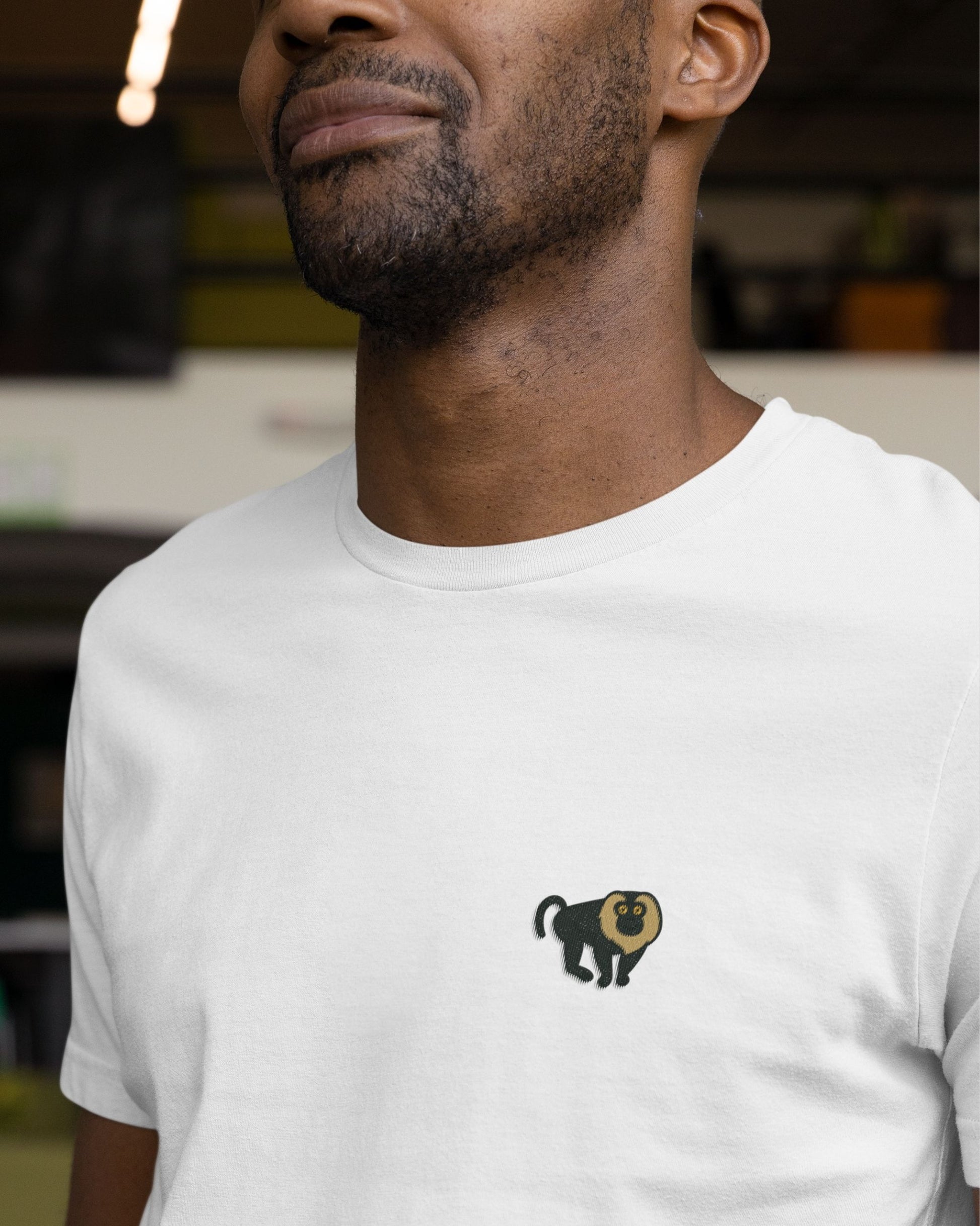 man wearing Lion tailed macaque embroidered wildlife t shirt in white by Tucktribe