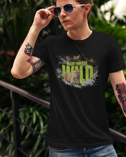 Person wearing a black t-shirt with a tiger graphic and 'Made for the Wild' text, outdoors.