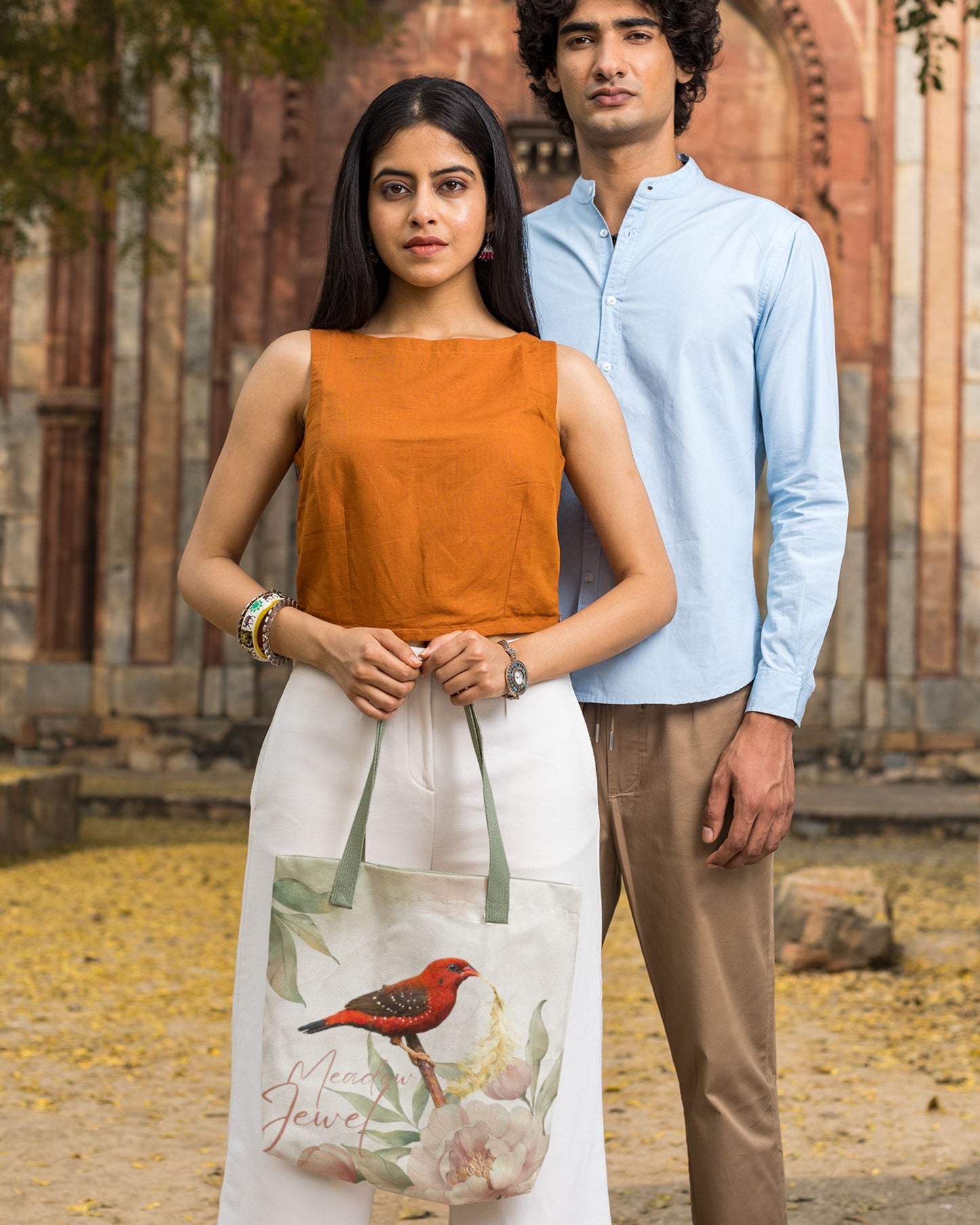 Two people standing outdoors with a scenic background