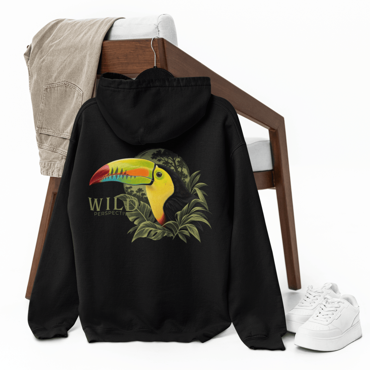 Toucan wildlife graphic on black oversized hoodie with Wild Perspective typography