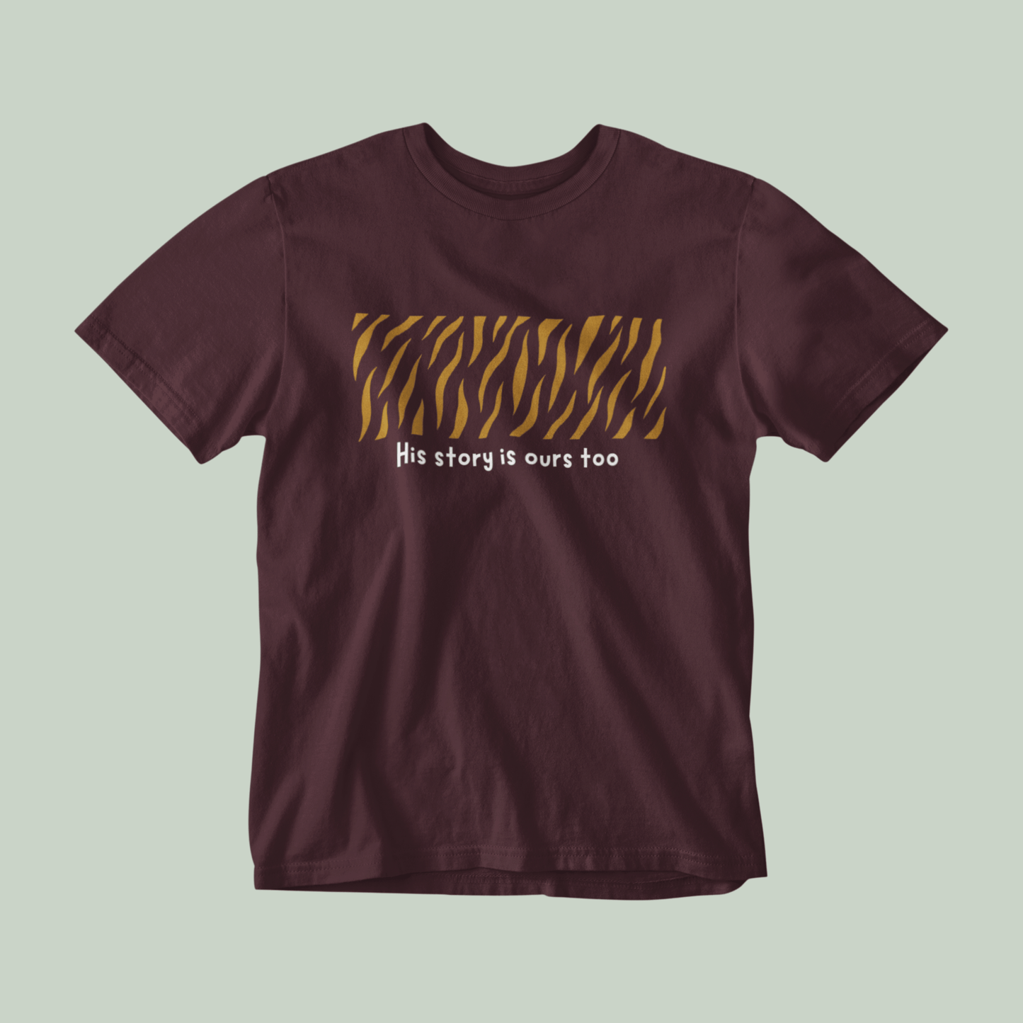 Maroon t-shirt with tiger stripe design and text on a light green background