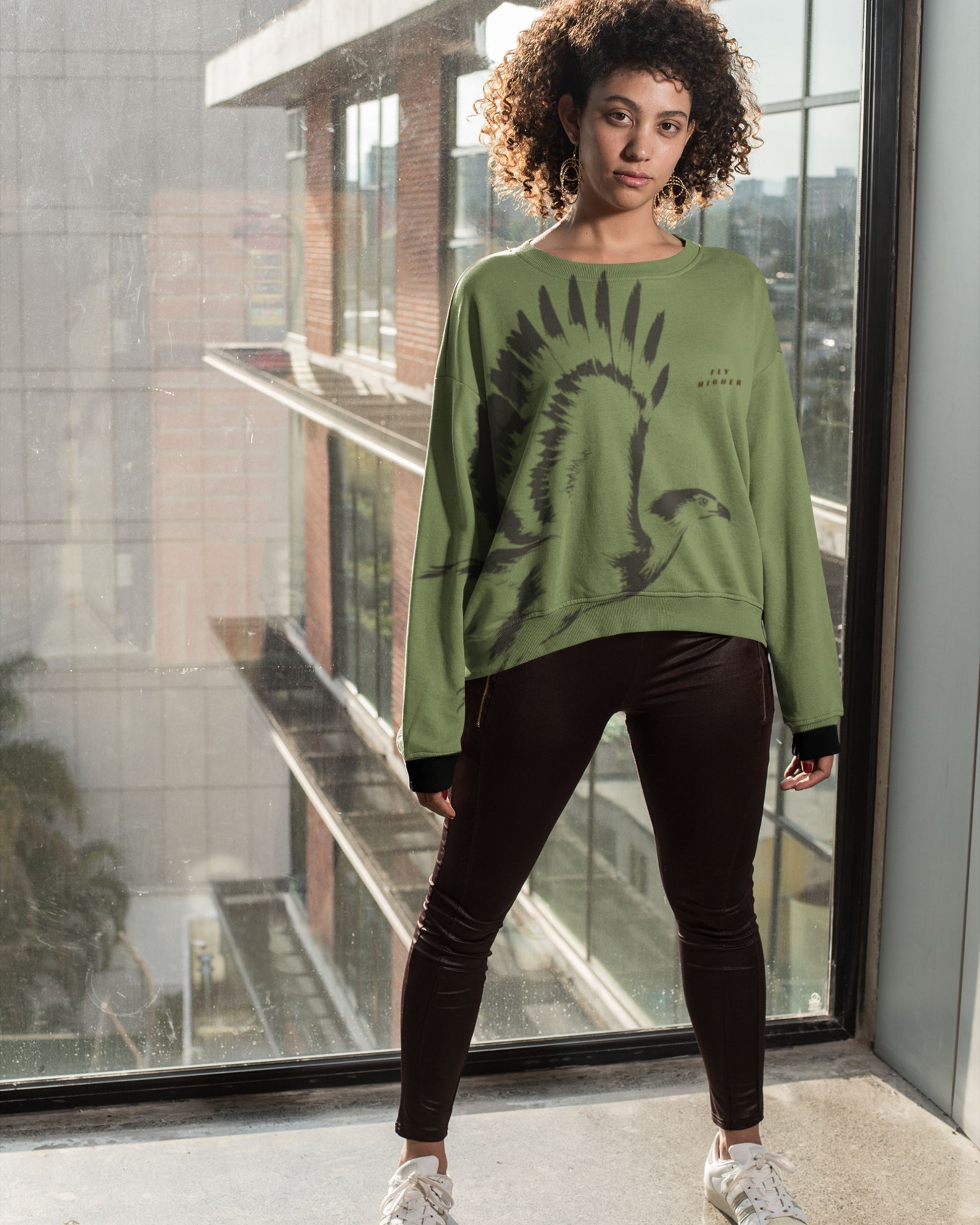 Minimalist osprey in flight wildlife artwork featured on a premium unisex sweatshirt