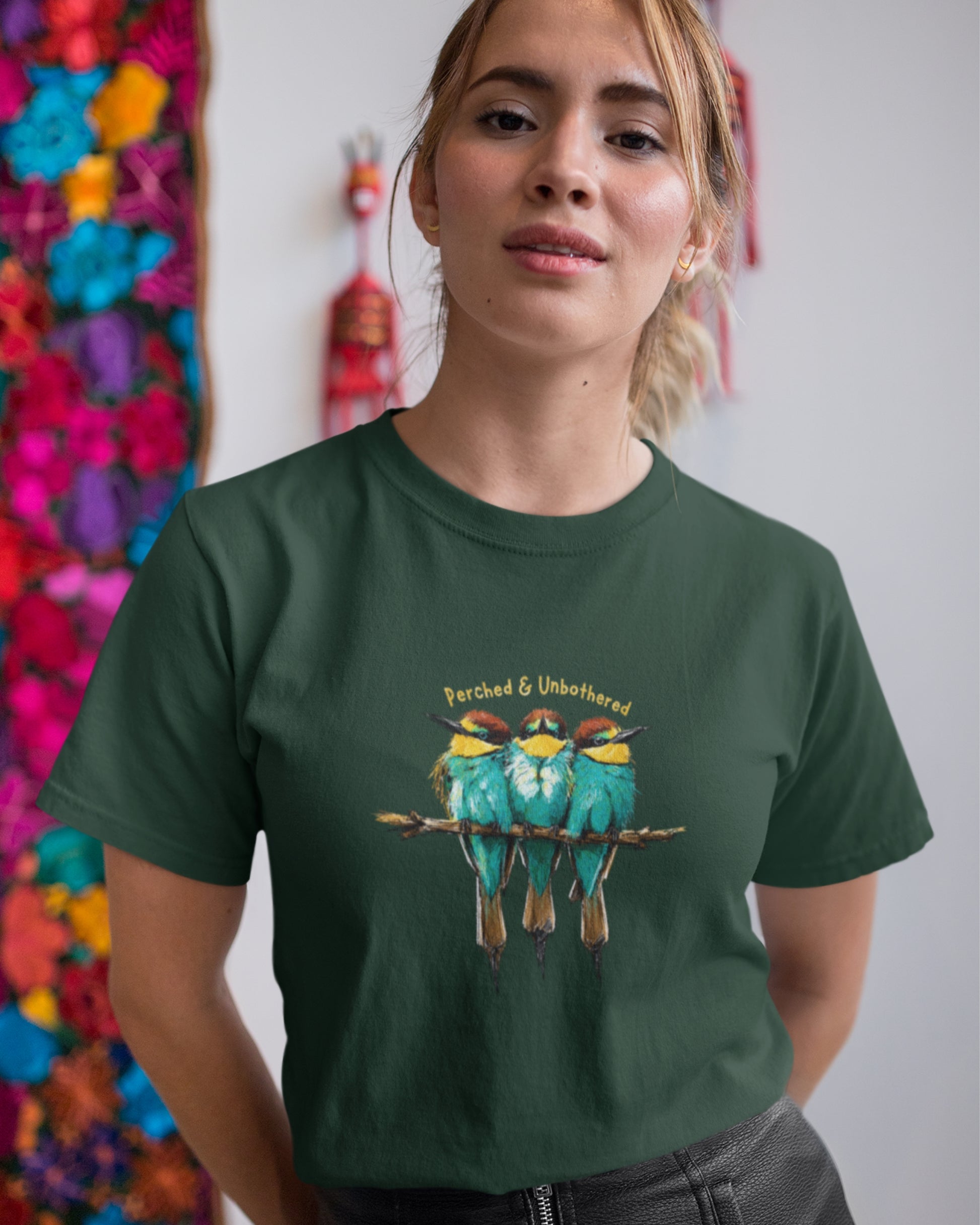 Woman wearing a Green tucktribe Bee-Eater unisex T-shirt featuring colourful bird wildlife artwork inspired by Rashmi Dsouza