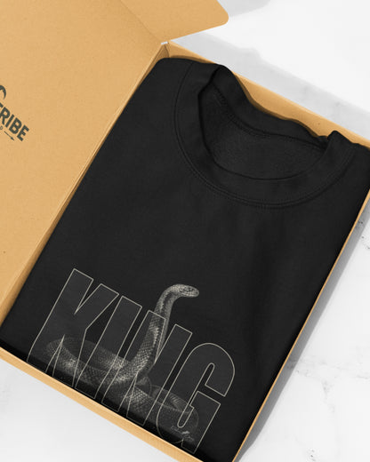 King Cobra wildlife T-shirt featuring detailed Ophiophagus hannah snake artwork with bold KING typography placed in open carton box.