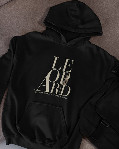 Black oversized hoodie featuring leopard graphic and Walking Between Shadow and Light typography