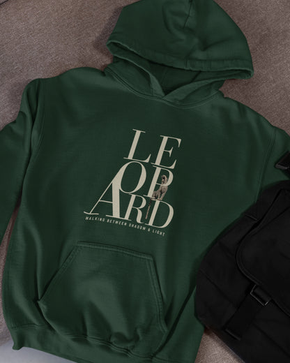 Green oversized hoodie featuring leopard graphic and Walking Between Shadow and Light typography