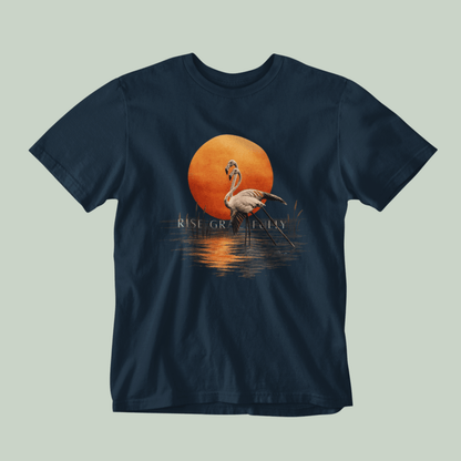 A Navyblue Tucktribe short-sleeve crewneck t-shirt featuring a graphic print of a pink flamingo standing in front of a large orange sun over water, with the text 'RISE GRACEFULLY' printed below the sun.