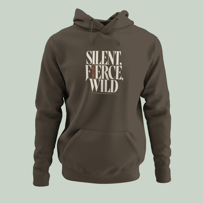 A Olive Green pullover hoodie with a front kangaroo pocket and drawstrings, featuring the text 'SILENT, FIERCE, WILD' printed in a beige and brown graphic on the chest, set against a solid sage green background.