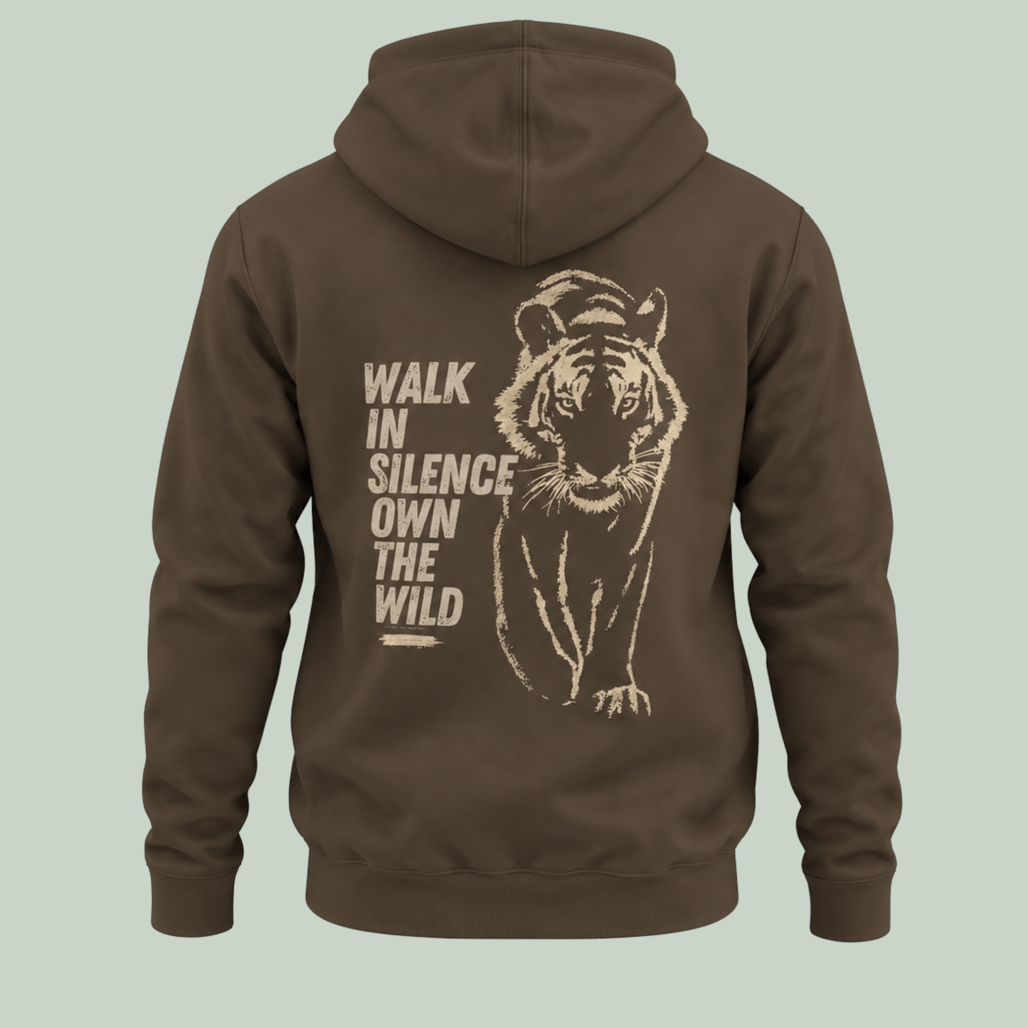A Olive green pullover hoodie shown from the back, featuring a large beige graphic of a tiger and the text 'WALK IN SILENCE OWN THE WILD' printed on the back, set against a solid light sage green background.