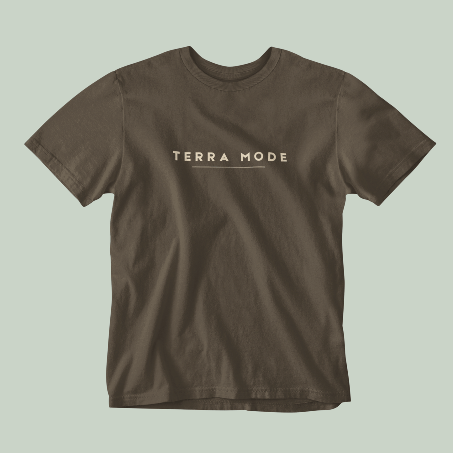 Tucktribe Brown t-shirt with 'Terra Mode' text on a light green background