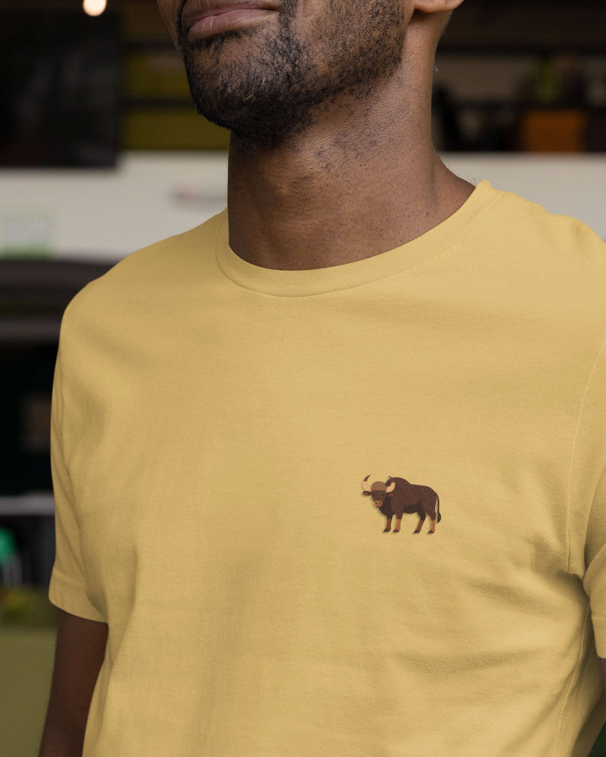 man wearing Beige Supima cotton t-shirt with embroidered Indian Gaur wildlife design by Tucktribe