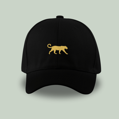 Tucktribe Black cap with a gold panther logo on a light gray background