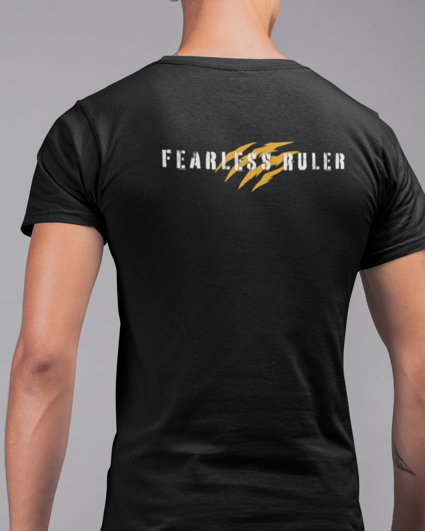 Back view image of a man wearing a black tshirt with text FEARLESS RULER on it