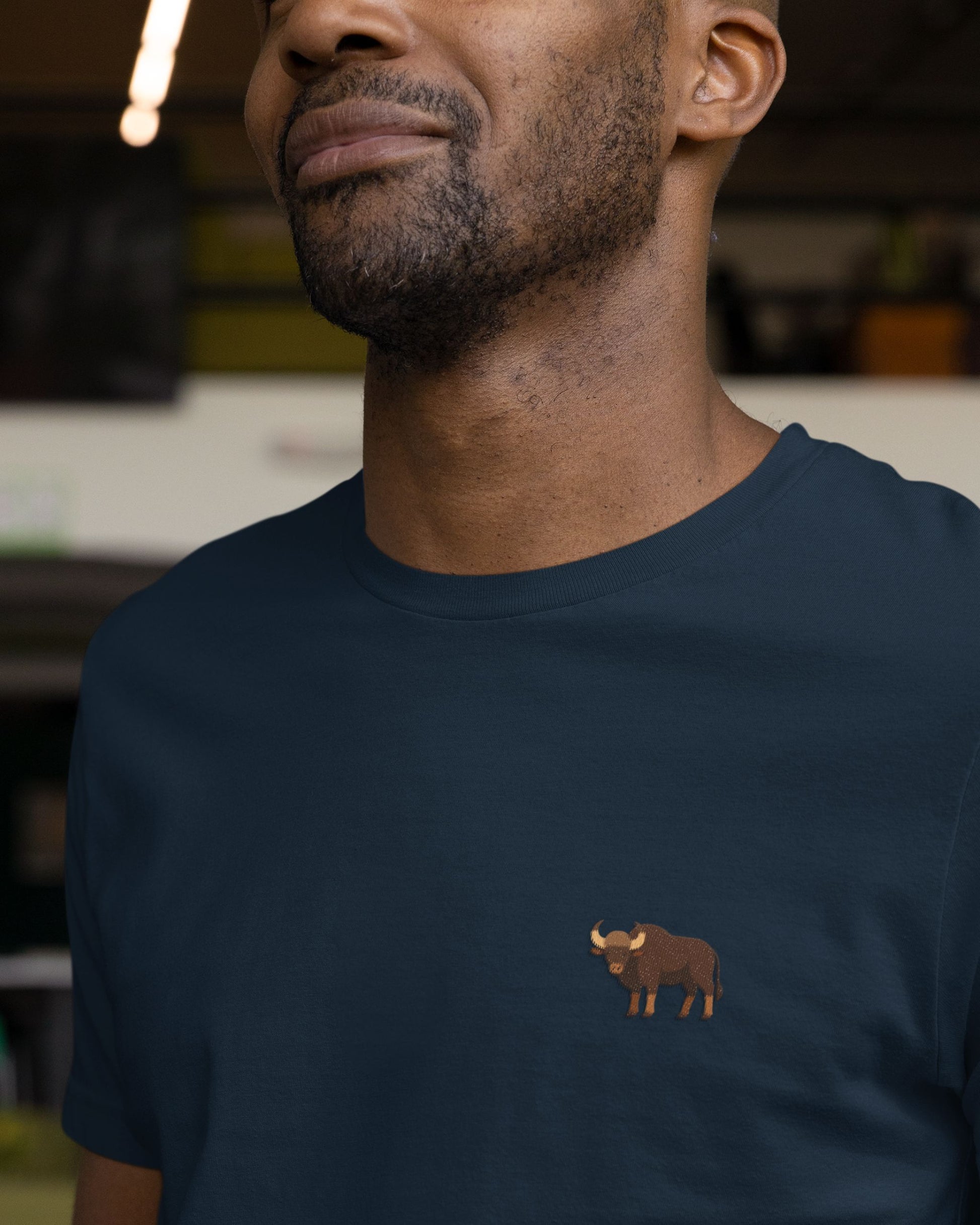 man wearing navy blue Supima cotton t-shirt with embroidered Indian Gaur wildlife design by Tucktribe
