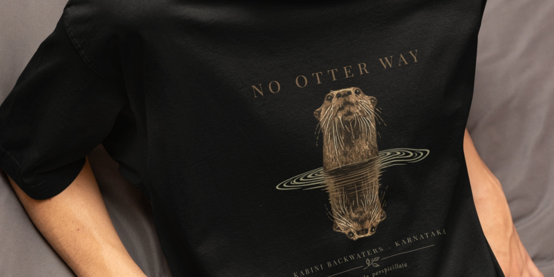 closeup of a tucktribe tshirt with a otter graphic