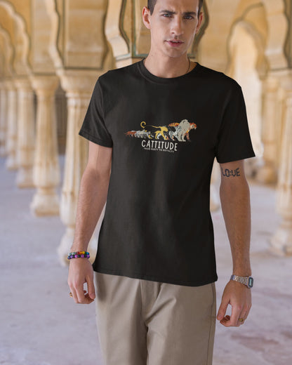 Man wearing a black tucktribe t-shirt with a graphic design and text, standing in front of architectural columns.