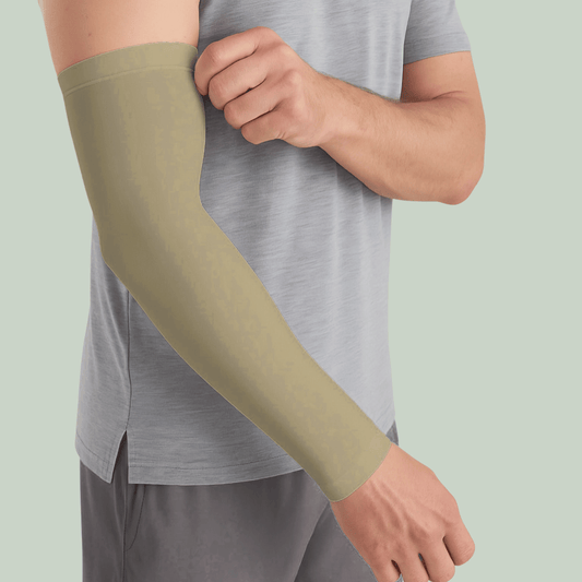 Person wearing a Tucktribe Desert sand arm sleeve against a light green background