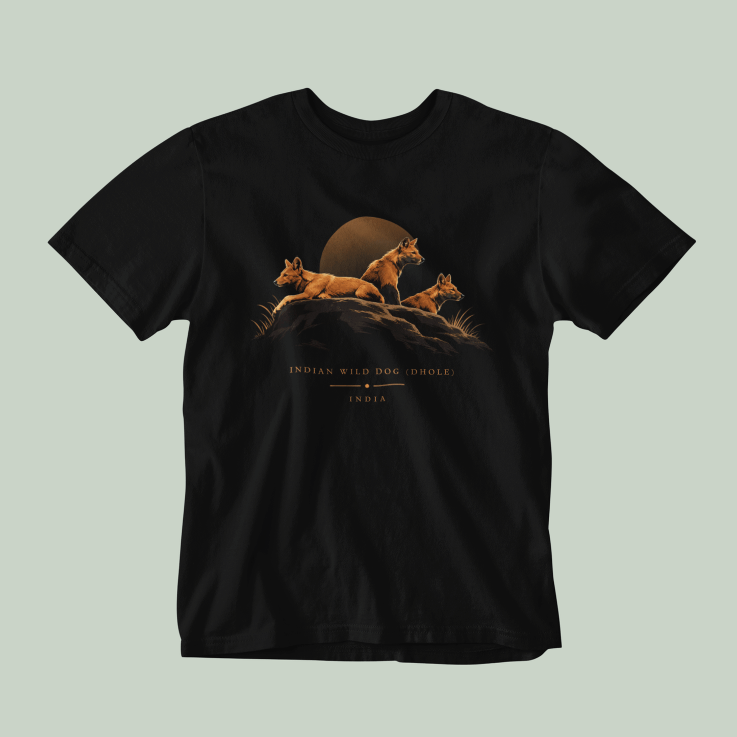 Dhole wildlife Black T-shirt featuring three Indian wild dogs on a rocky landscape with sunset-inspired artwork