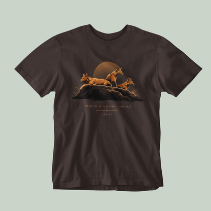 Dhole wildlife Brown T-shirt featuring three Indian wild dogs on a rocky landscape with sunset-inspired artwork