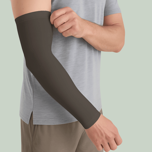 Person wearing a Tucktribe Earth brown arm sleeve on a light green background