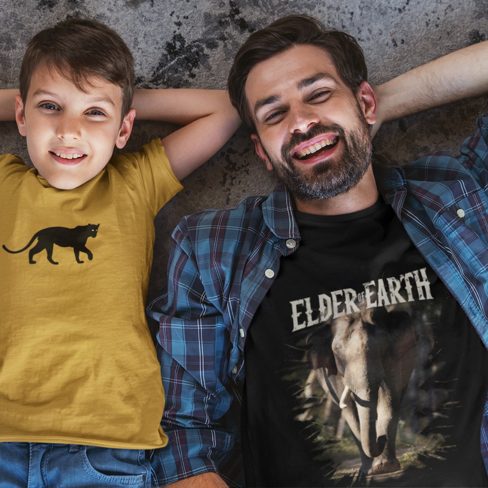 a man and kid smiling and wearing tshirt with elephant and panther graphic