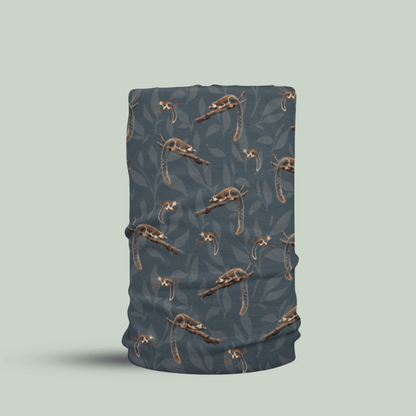 A tubular neck gaiter or face mask featuring a repeating pattern of grizzled giant squirrel with white accents over a dark slate blue-gray background, shown on a solid light sage green backdrop.