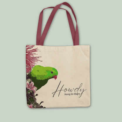 Tucktribe Tote bag with a hanging parrot design and 'Howdy hang in there' text on a light gray background