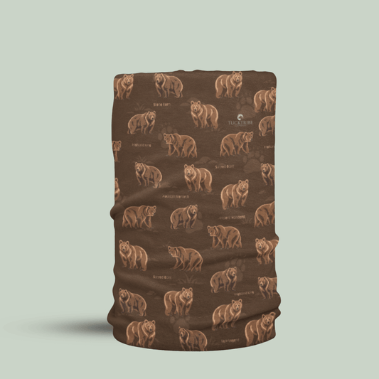 A brown neck gaiter or face mask featuring a repeating pattern of brown bears and small text, shown on a light sage green background.