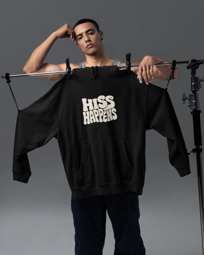 Model standing with Black tucktribe unisex hoodie featuring Hiss Happens typography on the front for wildlife lovers. 