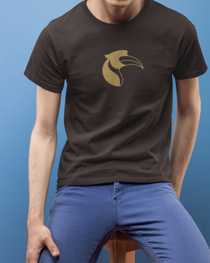 Person wearing a brown tucktribe t-shirt with a gold hornbill logo against a blue background